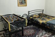 آپارتمان مبله تکخواب همکف با دسترسی خوب در مشهد | اتاق خواب با میز فوتبال دستی حرفه‌ای